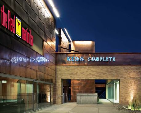 To maximize the square footage of Village Pointe East, Brown built a lower level into the sloping site. (That level now houses a daycare center.) The abundant use of copper, plantings of native grasses, and sleek lighting fixtures present a sharp contrast to the nostalgic "lifestyle center" across the street.