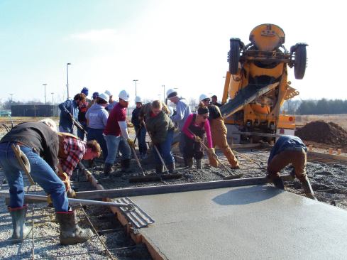 Students pouring concrete for the main slab.