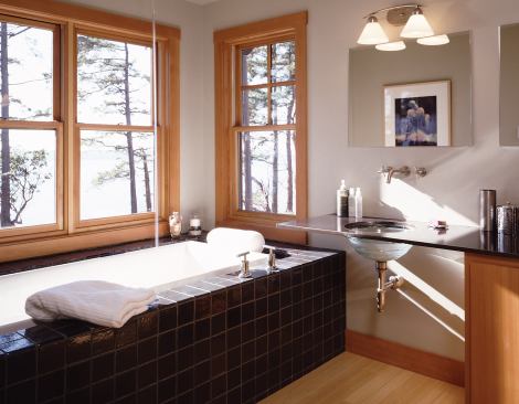 Downpours aren’t limited to rainy days at this Northwest home. Wall spouts above the undermount sinks keep the water flowing from above.