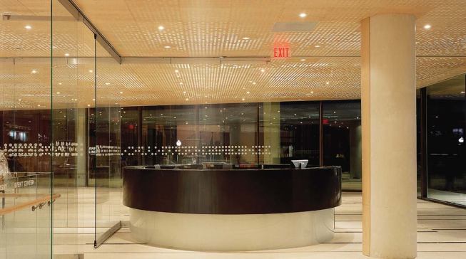 The perforated lobby ceiling (left) is Wingårdh's experiment with light and shadow. Light fixtures mounted above the maple-veneer panels, with a thin fabric scrim in between, make the irregular holes in the ceiling glow from within.