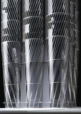 The cable structure on the surface of the eight perimeter tubes that make up the Al Sharq tower comprises a series of individual cables-up to 2 inches in diameter and spaced 60 inches apart-that skim the surface and are anchored to the structural members of the shear walls extending out from the core. The tubes taper as the shear walls between them get thicker at the building's base, and the cables are gathered and attached in groups to the building's foundation.