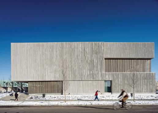 Wood-slat screens cover portions of the glazing at the lobby and second-level terraces.
