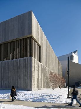 The wood-slat screens are a nod to the process of board-forming the concrete that makes up the rest of the exterior.