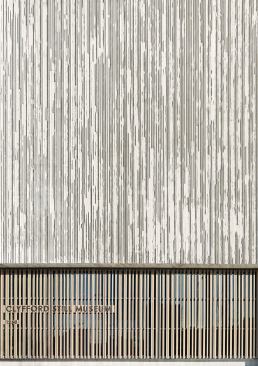 View of entrance and board-formed concrete walls.