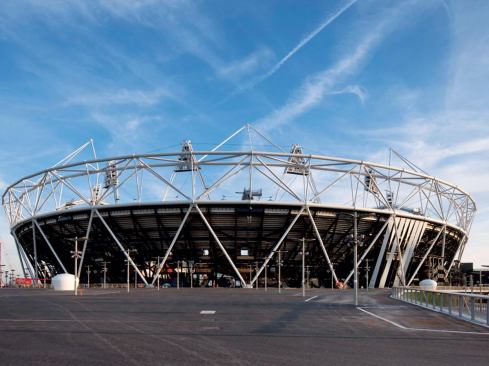 Olympic Stadium designed by Populous with structural engineer Buro Happold. The white structural members support the cable-net roof system while the black structural members support the upper-tier seating.