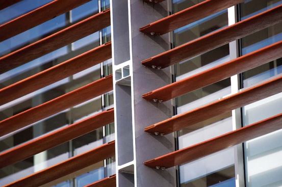 Metal spacers delineate window bays while also providing an anchor point for window-washing platforms to be affixed to the side of the building. 