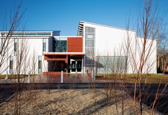 The entrance to the IFAW headquarters is located at the northeast corner of the middle shed, and the wood boardwalk and siding, as well as the glass, begin to set the material vocabulary for the rest of the complex.