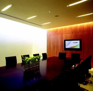 Clean lines and an elegant, but neutral palette define the aesthetic of Lucifer Lighting's new headquarters. Natural light reaches all parts of the building including the reception area and the break room. An extensive art collection is showcased throughout the facility, and the ceiling treatment of the corridor adjacent to the main conference room recalls the architectural form of architect Louis I. Kahn's Kimball Art Museum. The main conference room is equipped for numerous lighting scenarios. Skylights, coupled with high-bay fixtures provide an abundance of light in the factory.