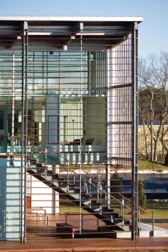 A system of stationary wood louvers covers the double-height glazing on the courtyard walls. The louvers are 7 inches wide, and 1 1/2 inches thick and provide sunshading for the open office areas within the building while still admitting ample daylight.