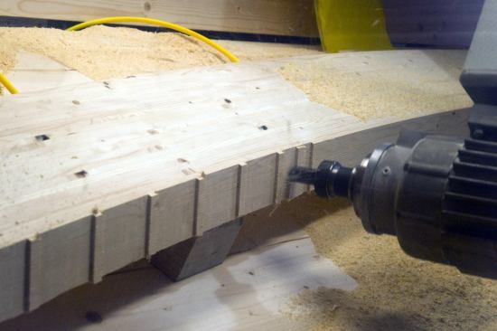 CNC machines cut seat cuts into each of the curved beams.