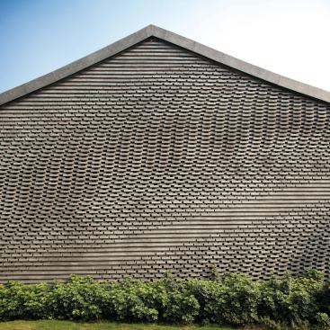 The masonry courses alternate at varying depths to create a play of light and shadow across the wall surface.