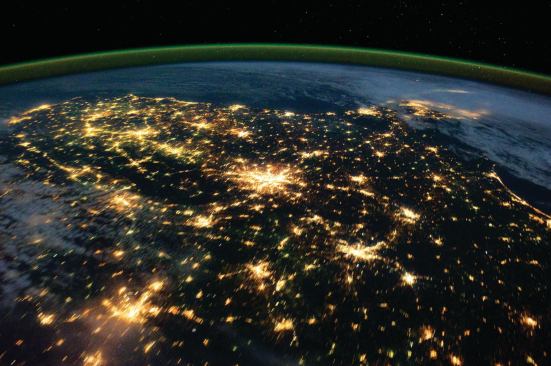Sky glow and city lights photographed in a night-pass view of the southeastern U.S. from the International Space Station in 2011. Atlanta is shown at the center; the Florida peninsula appears under clouds on the right.