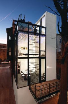 Thin, structural steel rods create a refined backbone for Barcode House, a glass addition to a Washington, D.C. rowhouse.