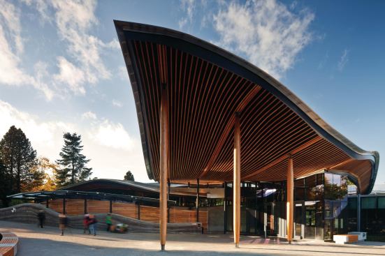 Underneath the canopy, the roof plane is lined in wood beams and supported by wood-clad columns. The use of wood can contribute to the building’s goal of meeting the stringent Living Building Challenge because of the material’s sequestered carbon.
