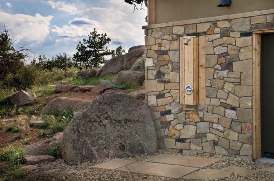 The rustic home appears to nestle into the surrounding landscape. All disturbed areas were reseeded with native grasses.