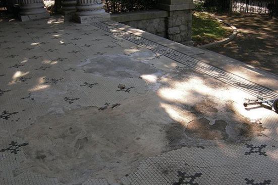 The porch’s tiled floor before its restoration.