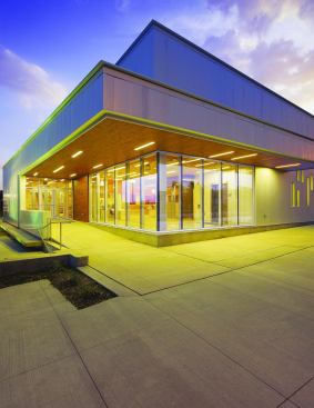 Visitors enter the building via a glass-clad lobby on the building's northeast corner. The ash planks harvested from the emerald ash borer-infected trees can be seen on the underside of the soffit over the main door, a prelude to the wood's use throughout the interior. Recessed strip lighting in a staggered pattern calls to mind the pattern of windows on the southern facade and elsewhere in the building.