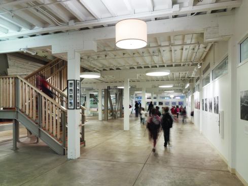 The first-floor commons is a central gathering space for the kindergarten, first, and second grade classes-who are required by law to be on the ground floor. "They have their own little universe down there," Pfau says. All classrooms and a music room open onto the commons, which also features an exhibit on the history of the building and its use as a denim manufacturing plant.