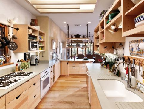 The kitchen features composite countertops made from recycled paper, Energy Star appliances, and recycled wood flooring.