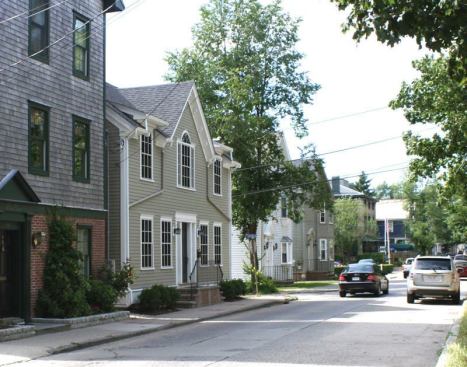 AFTER: By adding a gable, dormers, and a small amount of height to the existing footprint, the new building stands tall among its Victorian-era neighbors.