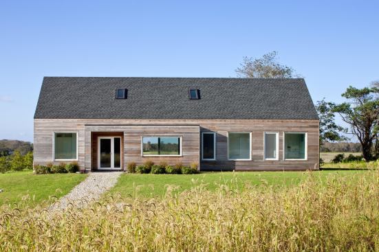 Located in a wildflower meadow, the cedar-clad gable-roofed is surrounded by native plantings and a drought-tolerant grass blend.