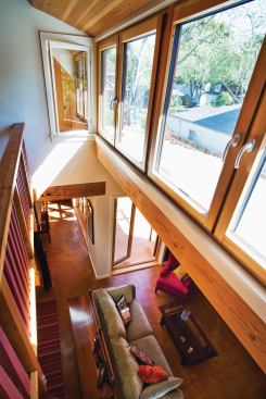 A band of dormer windows light the play loft and living spaces below. With minimal BTUs needed to heat the well-insulated house, the radiant tubing is limited to area rug locations, providing less heat more efficiently at a slightly higher temperature.