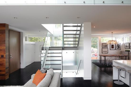 A mix of transparent and translucent glass on the stairwell distributes light throughout the home's core.