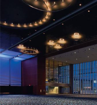 Suspended custom ring LED luminaires convey the presence of a chandelier and are a metaphor for drops of water.