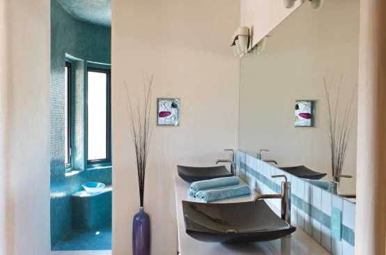 Bathroom

Kohler low-flow faucets and dual-flush toilets help keep water use low in each bathroom. Here, a pair of recycled-glass sinks sit atop a Caesarstone quartz counter. Kohler: 800.456.4537. www.kohler.com. Caesarstone: 818.779.0999. www.caesarstoneus.com.