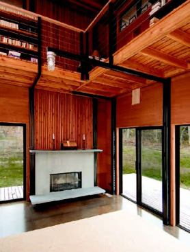 An assembly of stock steel columns, arms, and brackets supports many of the home’s key design elements, including the mahogany bookshelves.