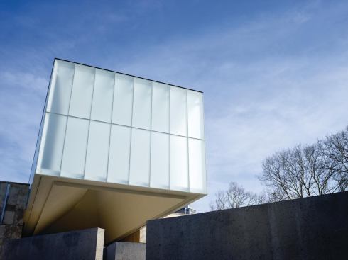 The distinctive light canopy of the new building, which cantilevers over an outdoor patio.