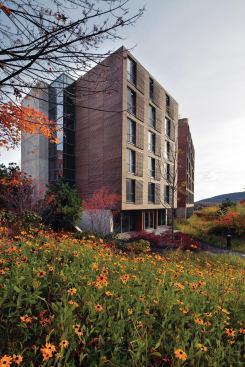 Located in the Berkshires, the new dormitory building at the Kripalu Center for Yoga & Health is a study in wood, glass, and concrete. Cypress cladding runs the length of the façade, and matching strips are worked into manually operated window shades for each guest room.