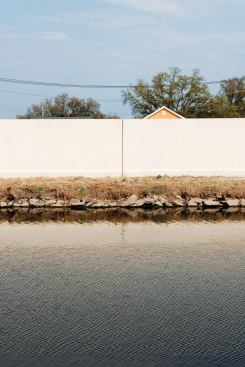View of houses over the wall of the Lopndon Avenue Canal in New Orleans.