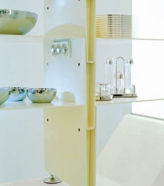 Fabricated from bent, white-painted steel, the shelves feature a band of three, two-inch-diameter “eyeball” fixtures, each directing the light of a single 2W white LED onto the housewares.