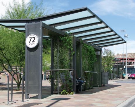 Architecture firm OTAK integrated lanscaping into their design for a transit center in Tempe, Ariz. Greenwall systems allow climbing plants to line the enclosures and help mitigate heat reflected fom the sidewalk in the desert environment. An angled roof system captures rainwater, directing it through a series of small pipes to irrigate the plant beds.