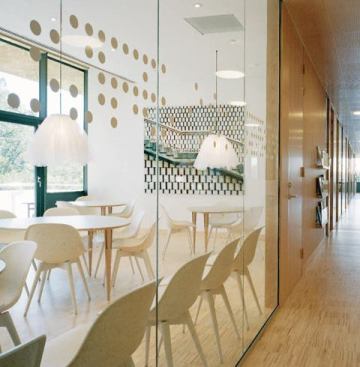 Decorative fixtures with tulle shade add a playful touch in the staff's lunchroom area. 