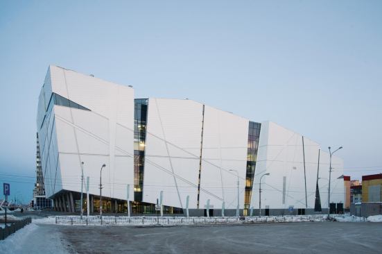  Because the days are often dark and desolate, van Egeraat focused on creating apertures in the façade to break up the elevation, rather than to allow for views. He cut vertical strips of glazing into the façade, which reinforce the irregular geometries of the building envelope. Integrated lighting in recessed lines that cut across the façade activates the building at night.