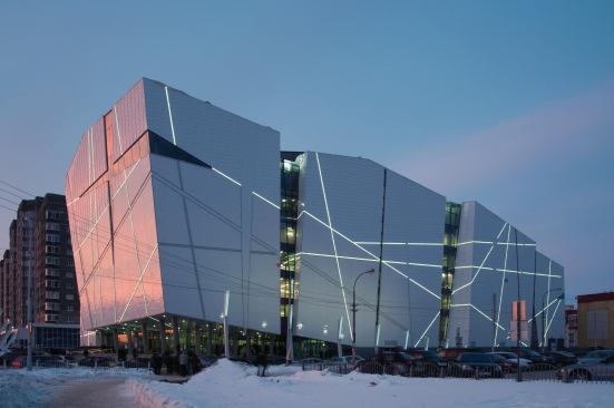 The web of coves cut into the façade light up at dusk.