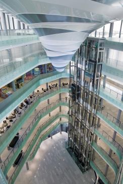 The southern end of the building is dominated by a full-height atrium, which is capped by a vortex-like lighting installation that descends from the ceiling.