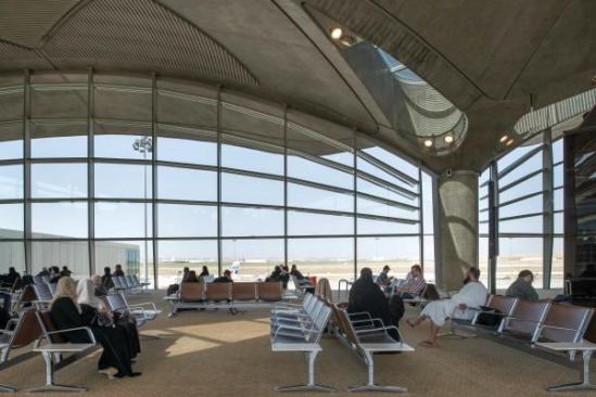 At the departure gates, fixed, arced louvers in front of the glass help to further shade the building. For additional energy offset, the air is preconditioned by plants and trees in open courtyards before it is diverted into the handling systems. “The airport’s open-air courtyards also incorporate pools, which are lined with dark tiles so that they are highly reflective—they ‘bounce’ indirect daylight back into the baggage claim areas,” Parr says.