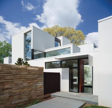 The suburban Jigsaw Residence's clerestory windows discreetly edit out views of close-by neighbors.