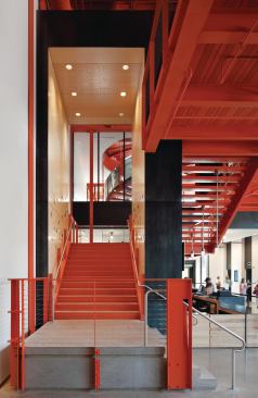 Behind the box office counter, a staircase leads to a second-floor gallery space.