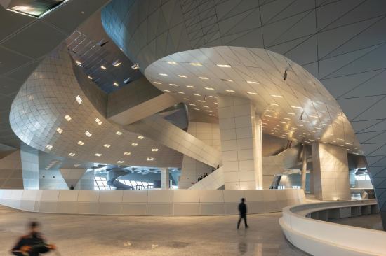 A series of stairs and bridges connecting conference rooms and public areas lends an urbanistic quality to the interior.