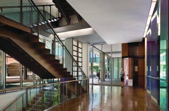 A breezeway cuts through the building, giving access to the high-ceilinged, stone-clad lobby in the southern volume.