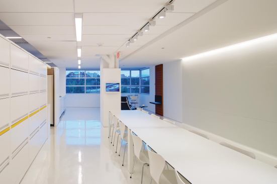 The main hallway isn't just for reception and circulation. A conference space, library shelving, and an employee lounge with a fireplace also are located there.



Conference Table

Kristalia



Sushi table

kristalia.itChair

Fritz Hansen



Arne Jacobsen Series 7 side chair

fritzhansen.comLinear fluorescent light fixtures

Zumtobel



High-efficiency ceiling fixtures

zumtobel.us