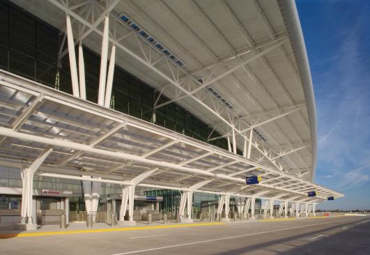 The design firm worked with Josef Gartner GmbH on the production of the glass curtain wall that encloses the ticket hall and baggage claim area on the two-story building. The system works to allow natural light into the building, while shading from a roof overhang helps to reduce glare and heat gain.

Curtain wall

Kawneer North America



Aluminum storefront 451 curtain wall

kawneer.com

Roofing

Wheeling Corrugating Co.



Metal decking

wheelingcorrugating.com

Lighting

Architectural Area Lighting



Roof overhang lighting

aal.net