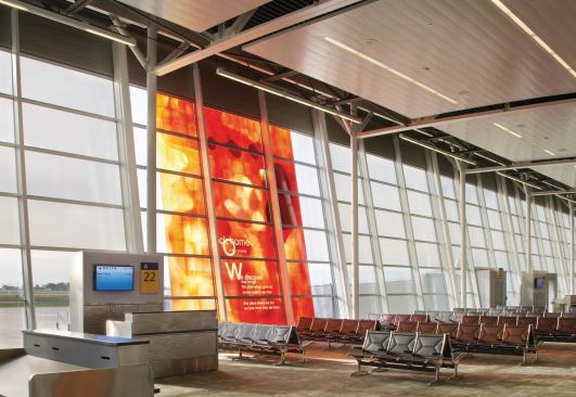 The arrival and departure gates are located down the two arms of the building that extend back from the main concourse. Here, HOK looked at choosing materials with high recycled content—including carpeting and wood finishes. All adhesives, sealants, paints, and coatings are low VOC.

Area Lighting

Pinnacle Architectural Lighting



Recessed and suspended fluorescent fixtures

pinnacle-ltg.comArt Glass

BGT Bischoff Glastechnik AG



Custom laminated fritte glass

bgt-bretten.deSeating

Herman Miller



Eames Tandem Sling Seating

hermanmiller.com