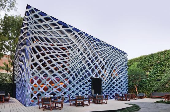 Designed by Rojkind Arquitectos, the two perforated steel templates that wrap the Tori Tori Restaurant and Lounge give the flat façade a three-dimensional effect.