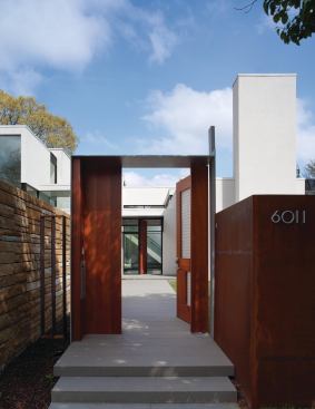 The front gate of the Jigsaw Residence in Bethesda hints at the layering of indoor and outdoor spaces that takes place throughout the house.