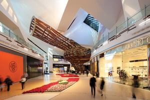  The building envelope, extra-tall ceiling heights, and sloping surfaces at Crystals presented several challenges when it came to the placement and accessibility of the light fixtures. Focus Lighting devised a system of ceiling slots to house the luminaires, which keep the ceiling planes free from “visual clutter.” During the day the space is infused with a complement of natural light from a series of skylights. 